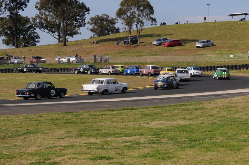 The field sweeps round Turn 2 hunting Chris Strode's Galaxie