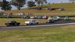 The field sweeps round Turn 2 hunting Chris Strode's Galaxie