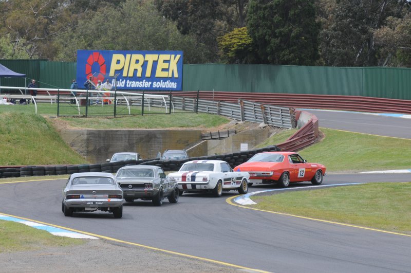 Darrin Davies, Darryl Hansen and Les Walmsley chase Keven Stoopman into Turn 2