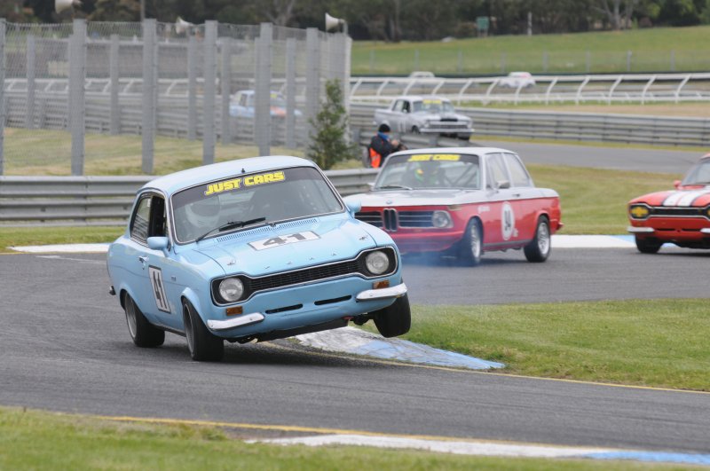 NSW Wild man Jerry Lenstra in the BDA Escort attacks the kerb into the main straight