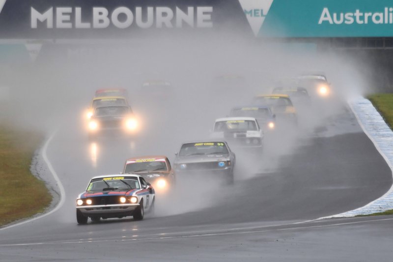 Jason Humble's Mazda waits to pounce on Andy Clempson's Mustang to take the wet race win.