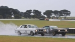 Spud Smith slithers down the inside of Dean Neville at Honda