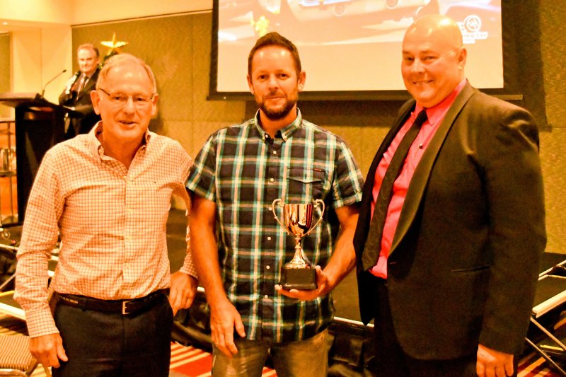 Fast father and son Jim and Darren Collins with their trophy