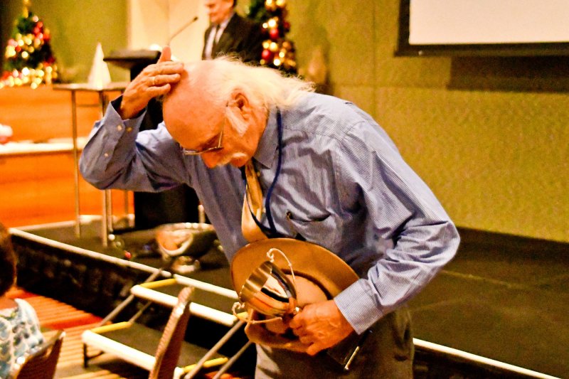 Inspector Holloway blesses himself after winning his cup