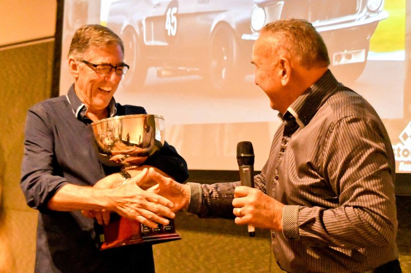 John Mann congratulates the new Champ on winning the John Mann Cup - and slips him a bill for the Island Magic tap.