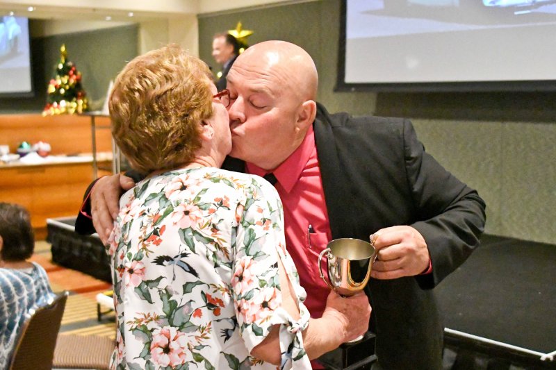 Sue Southouse collects Phil Barrow's cup and a smooch from The Genie