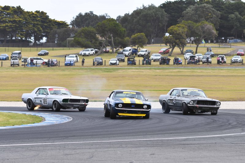 John Mann's Camaro in a silver Mustang sandwich