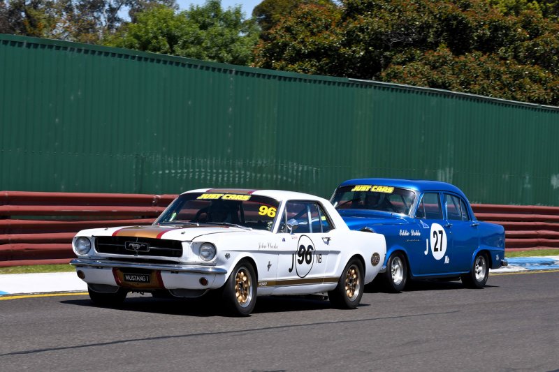 Eddie Dobbs' FE Holden gives John Clarke's Mustang a bit of hurry up