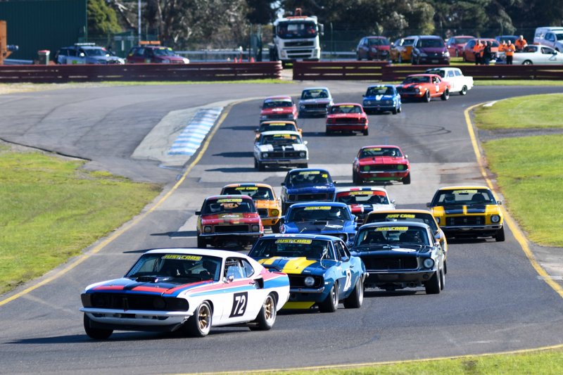 Andy-Clempson-leads-John-Mann-and-Darryl-Hansen-into-Turn-2
