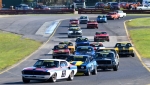 Andy-Clempson-leads-John-Mann-and-Darryl-Hansen-into-Turn-2