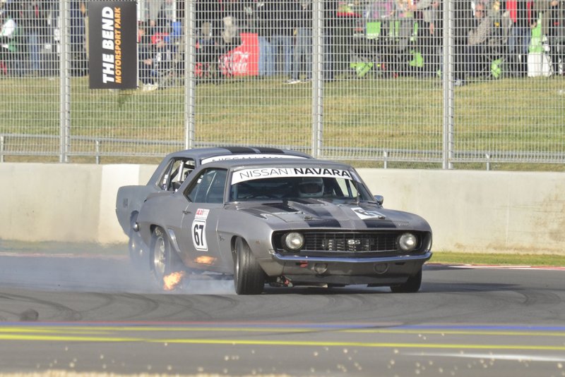 Graham-Jarrett’s-Camaro-locks-a-wheel-in-front-of-Graeme-Woolhouse’s-Mustang-in-Race-1