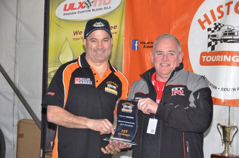 Nissan-Australias-Mark-Shepherd-hands-the-1st-Outright-trophy-to-Andy-Williams-who-also-won-the-Under-3500-Nc-and-Historic-Touring-Car-Cups.