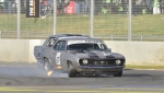 Graham-Jarrett’s-Camaro-locks-a-wheel-in-front-of-Graeme-Woolhouse’s-Mustang-in-Race-1