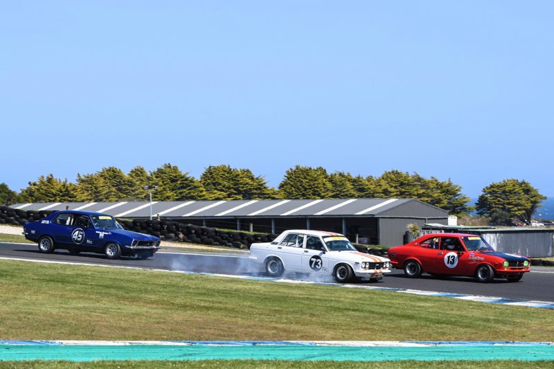 Divebomb-Dave_-Brown_s-super-rapid-Datsun-getting-under-Jim-McNiven_s-Mazda.-Phil-Wisewould-photo.