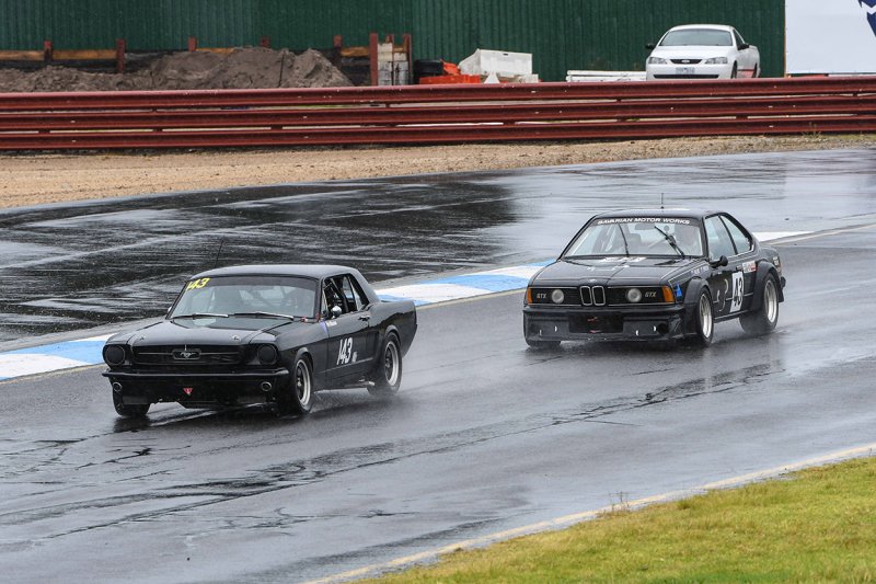 Black-on-black-on-blacktop.-Dean-How_s-635-BMW-chases-Pete-Mueleman_s-Mustang