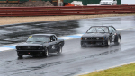Black-on-black-on-blacktop.-Dean-How_s-635-BMW-chases-Pete-Mueleman_s-Mustang